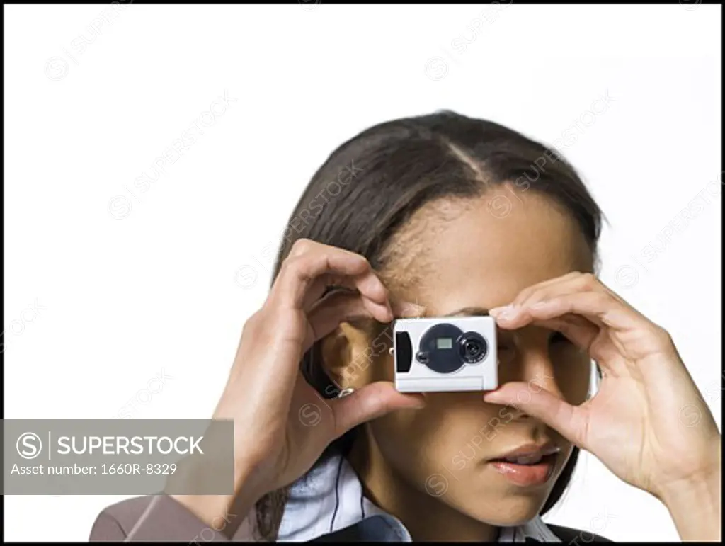 Close-up of a young woman using a digital camera