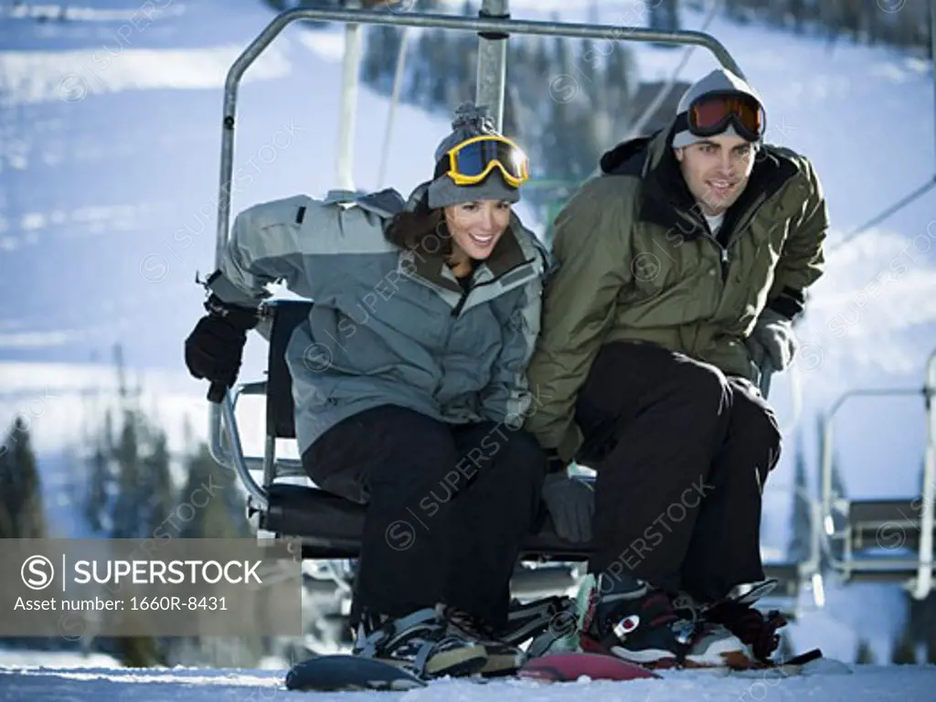 Young couple getting off a ski lift