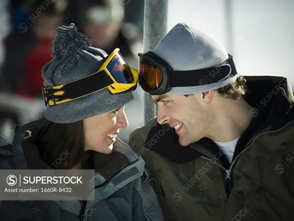 Close-up of a young couple looking at each other on a ski lift