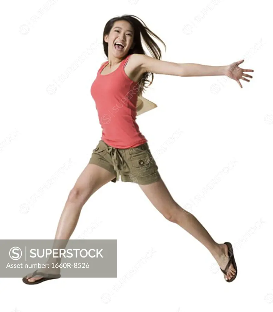 Portrait of a young woman jumping