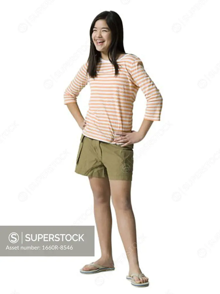 Teenage girl standing with her hands on her waist