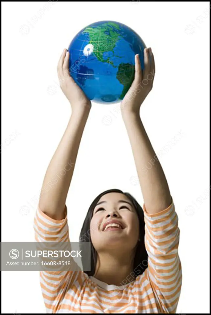 Close-up of a teenage girl holding a globe