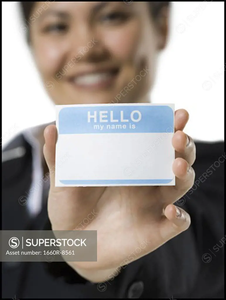 Portrait of a young woman holding a nametag
