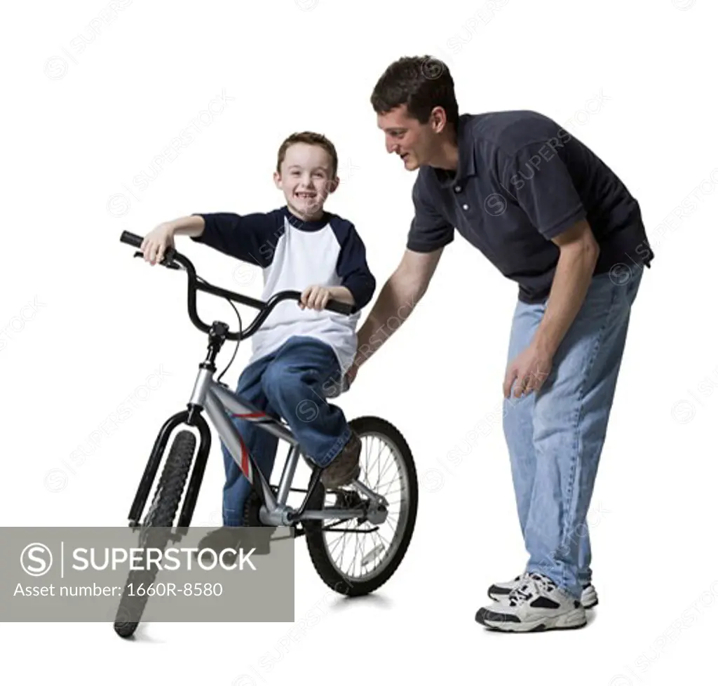 Father teaching his son to ride a bicycle