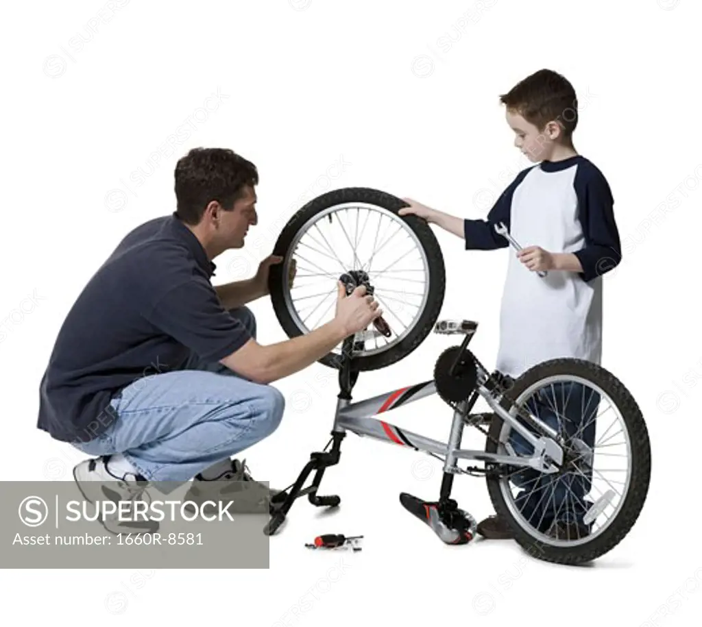 Father and son repairing a bicycle