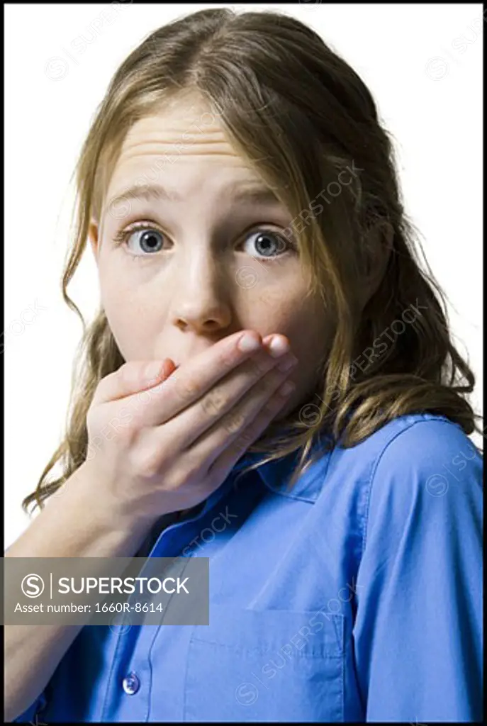 Portrait of a girl covering her mouth with her hand