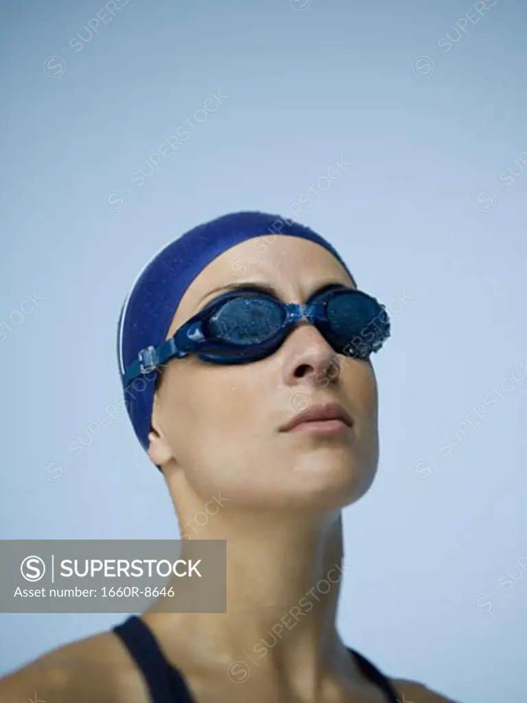 Close-up of a woman wearing swimming goggles and a swimming cap