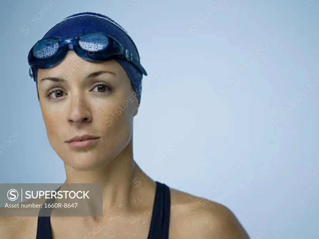Portrait of a woman wearing swimming goggles and a swimming cap