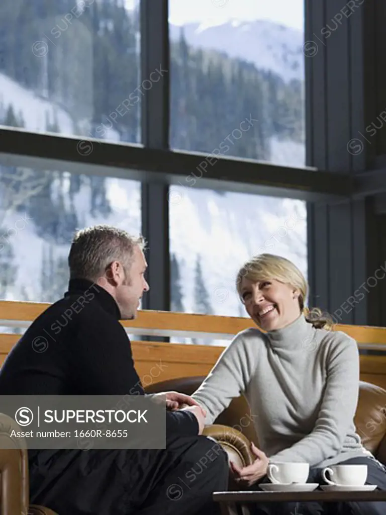 Man and woman chatting in a ski lodge