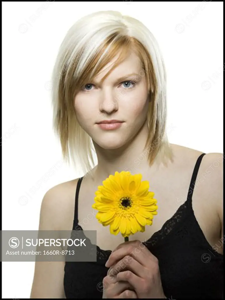Portrait of a young woman holding a flower