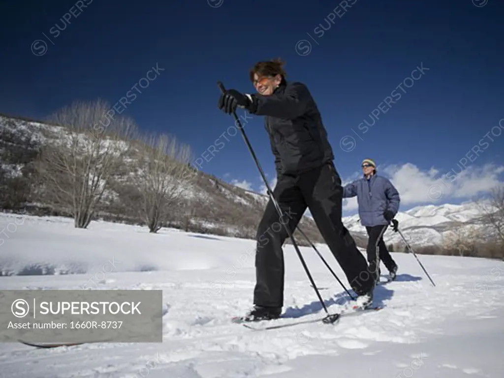 Man and woman cross country skiing