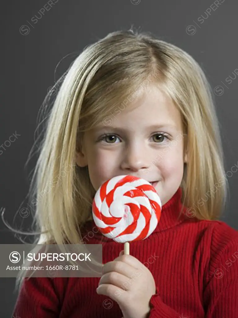 Portrait of a girl holding a lollipop