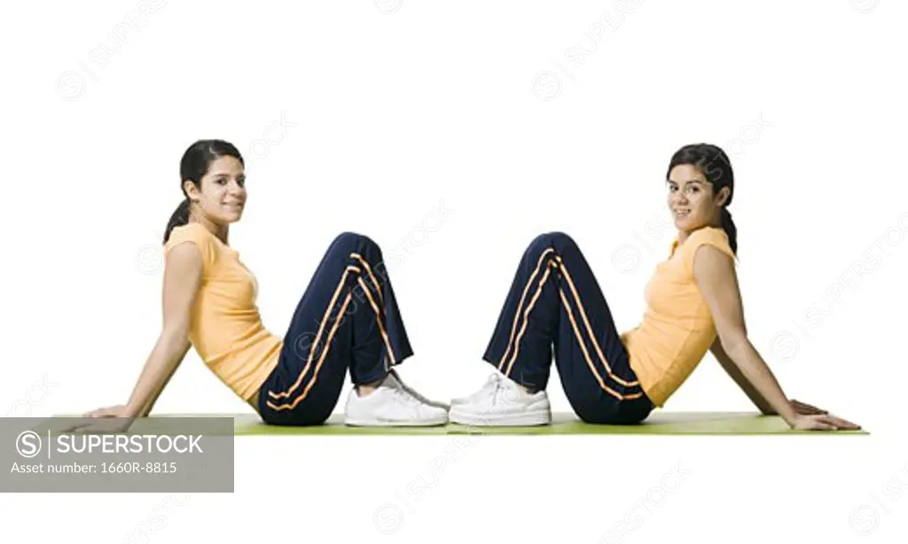 Portrait of two teenage girls exercising