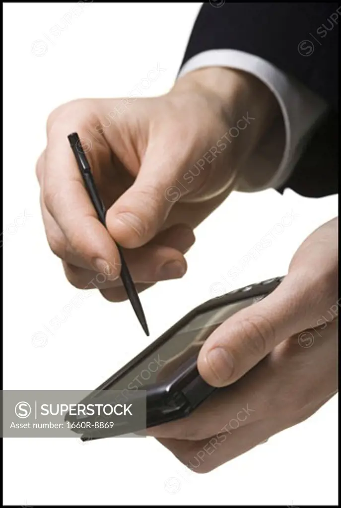 Close-up of a businessman's hand operating a personal data assistant