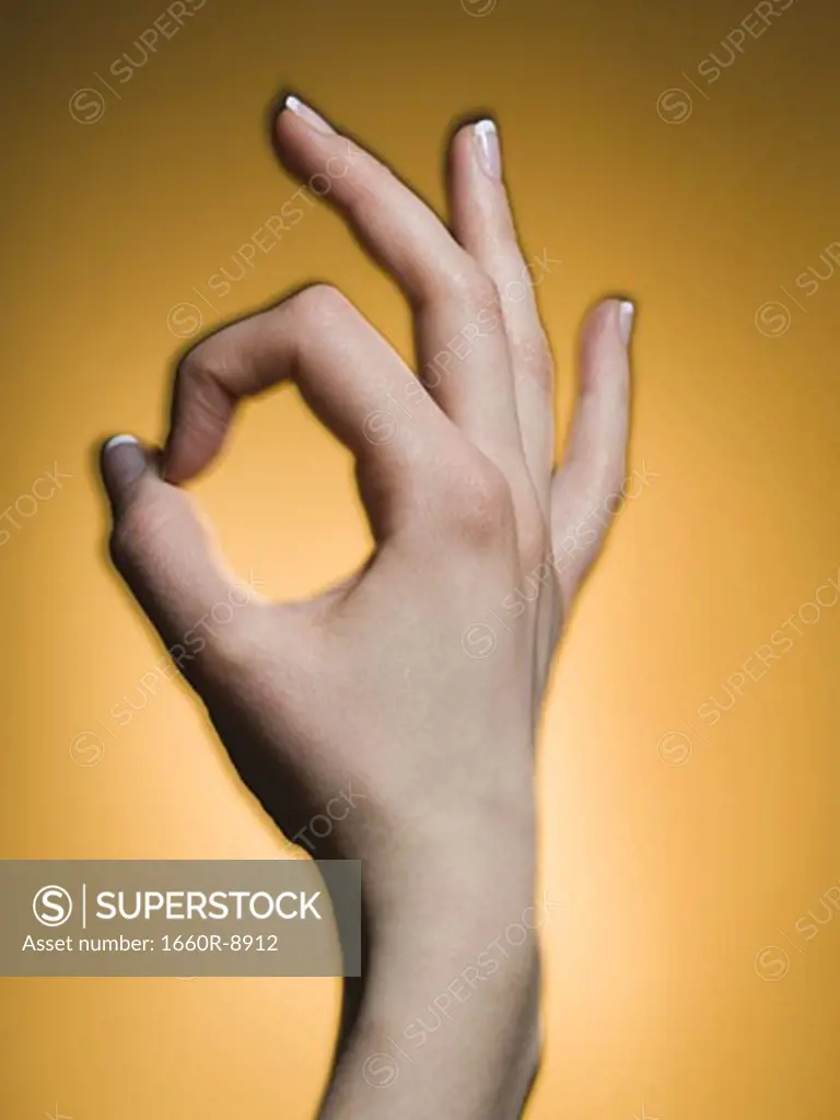 Close-up of a person's hand showing the ok sign