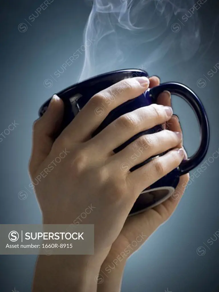 Close-up of a woman's hands holding a cup