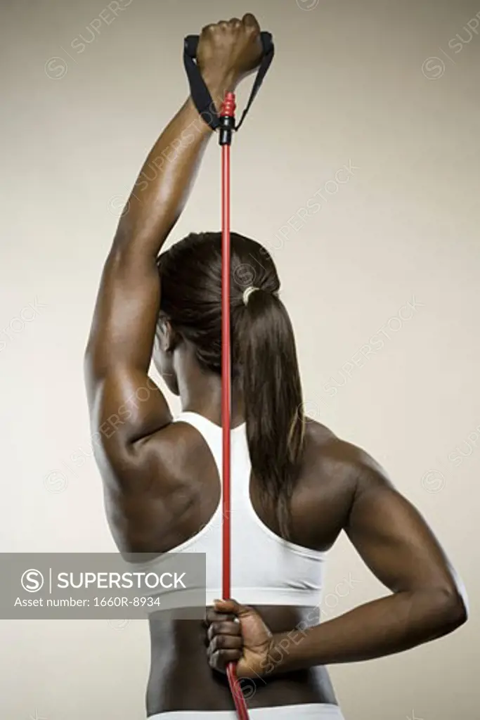 Rear view of a young woman exercising with a jump rope