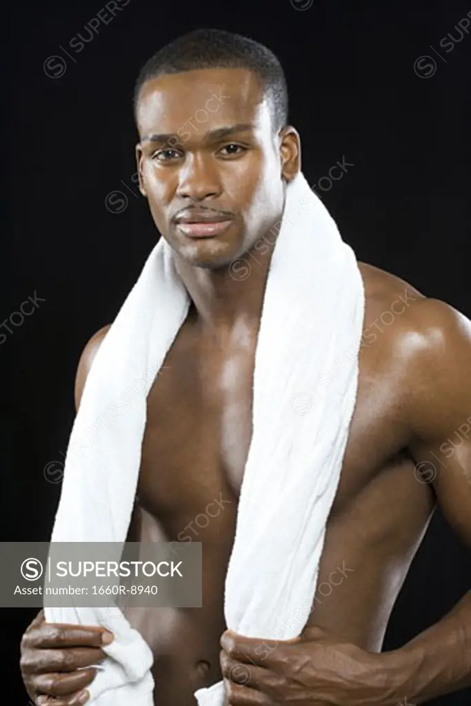 Portrait of a young man holding a towel