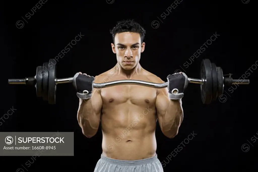 Portrait of a mid adult man lifting a barbell