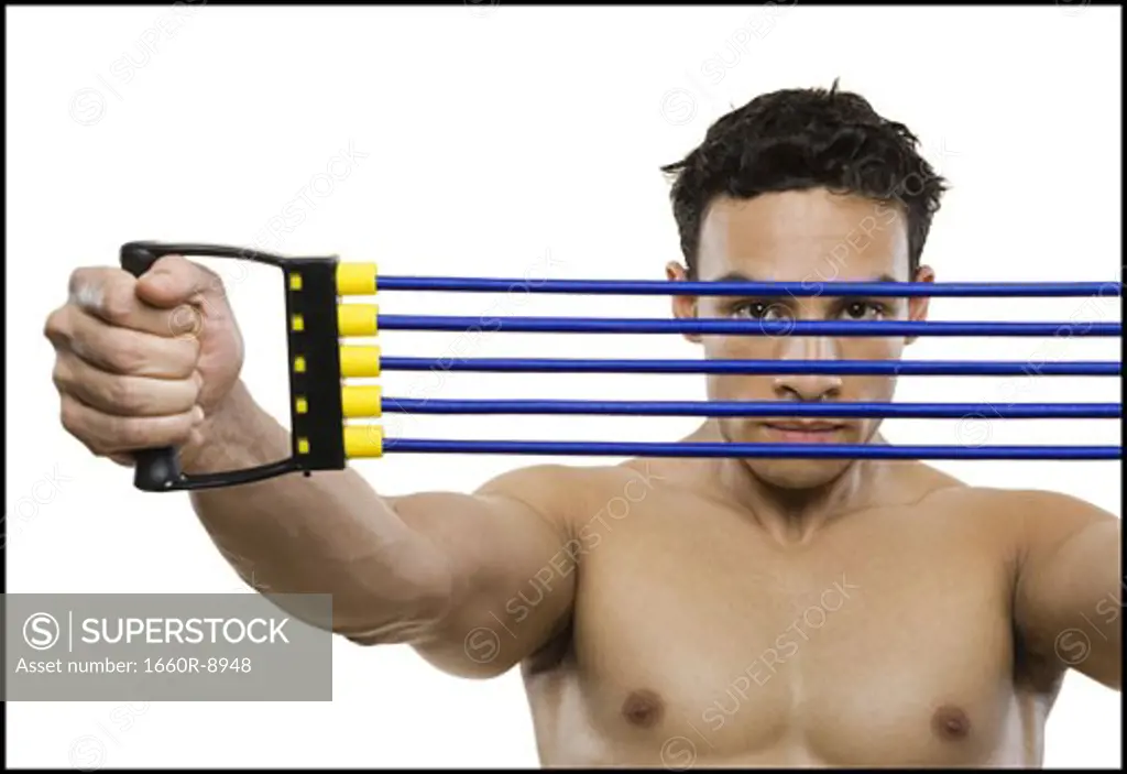 Portrait of a mid adult man stretching a resistance band