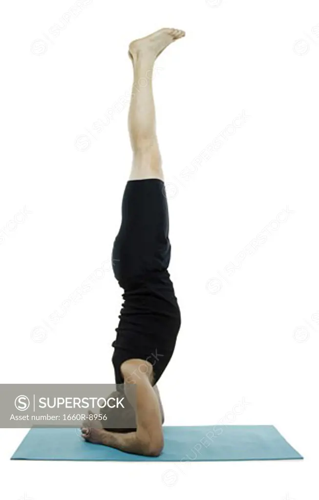 Profile of a man doing a headstand
