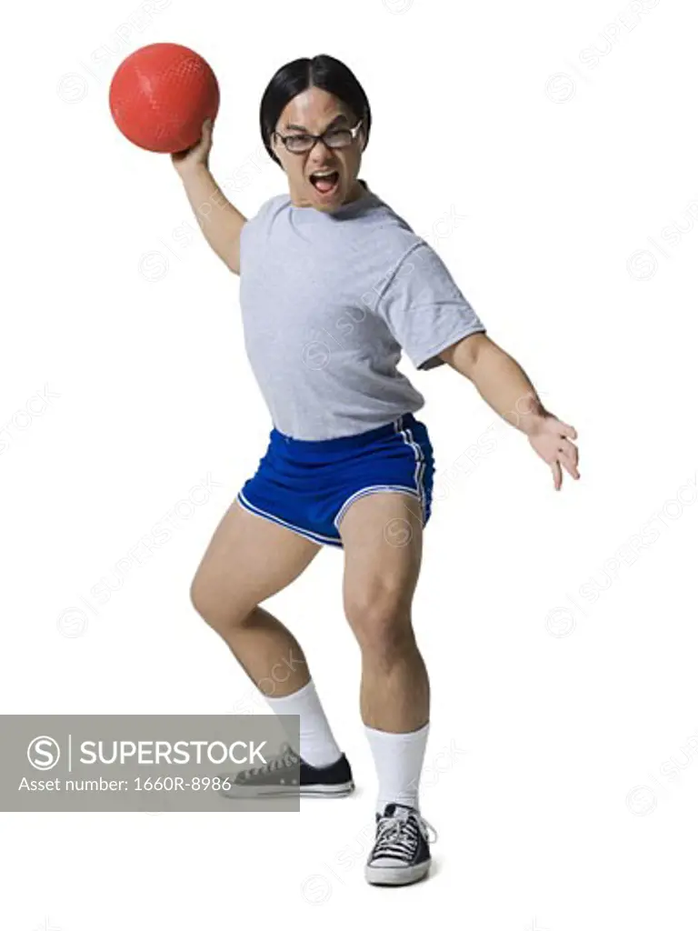 Portrait of a young man getting hit with a dodgeball