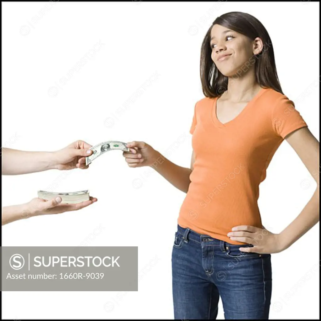 Girl taking dollar bills from a person's hand