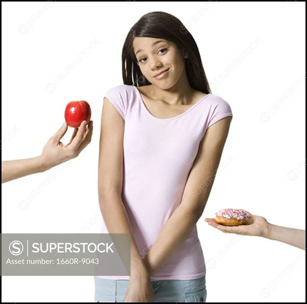 Close-up of two peoples hand's offering food to a girl