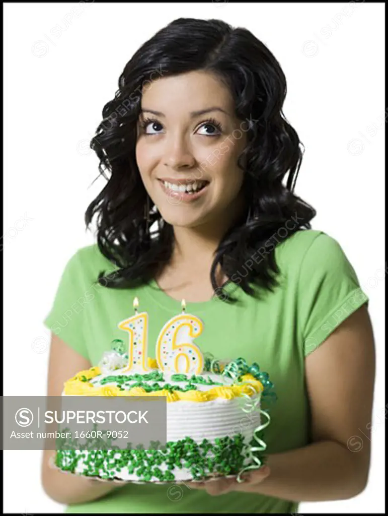 Close-up of a teenage girl holding a birthday cake
