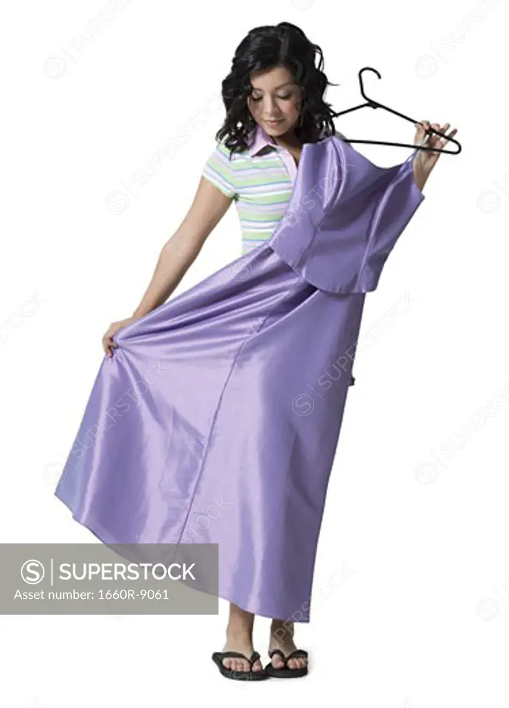 Teenage girl holding a dress