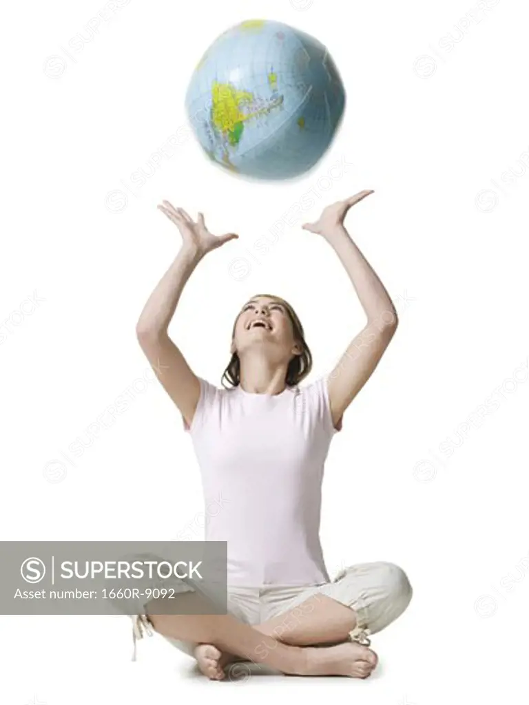 Girl playing with a globe