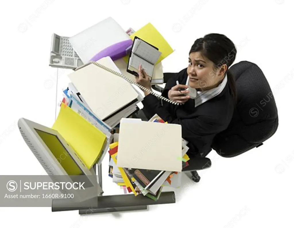 High angle view of a businesswoman multi-tasking in an office
