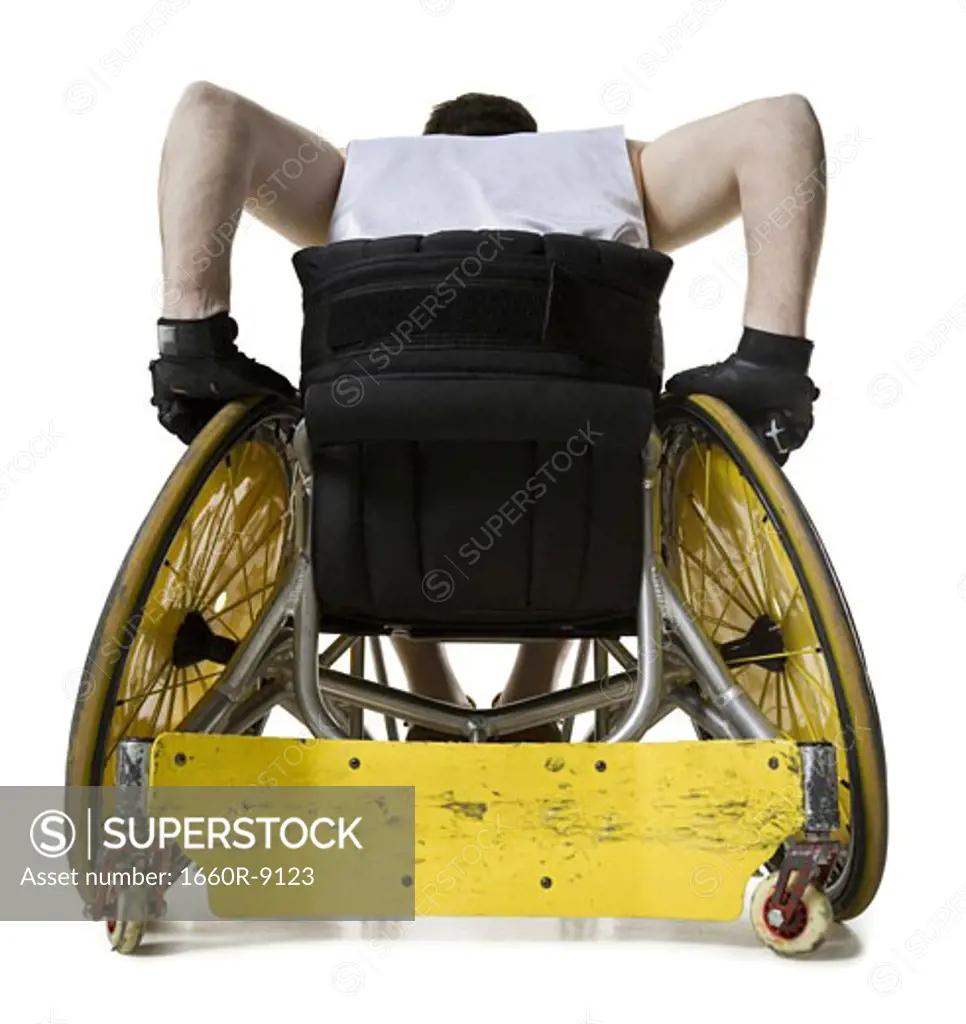 Rear view of a young man sitting in a wheelchair