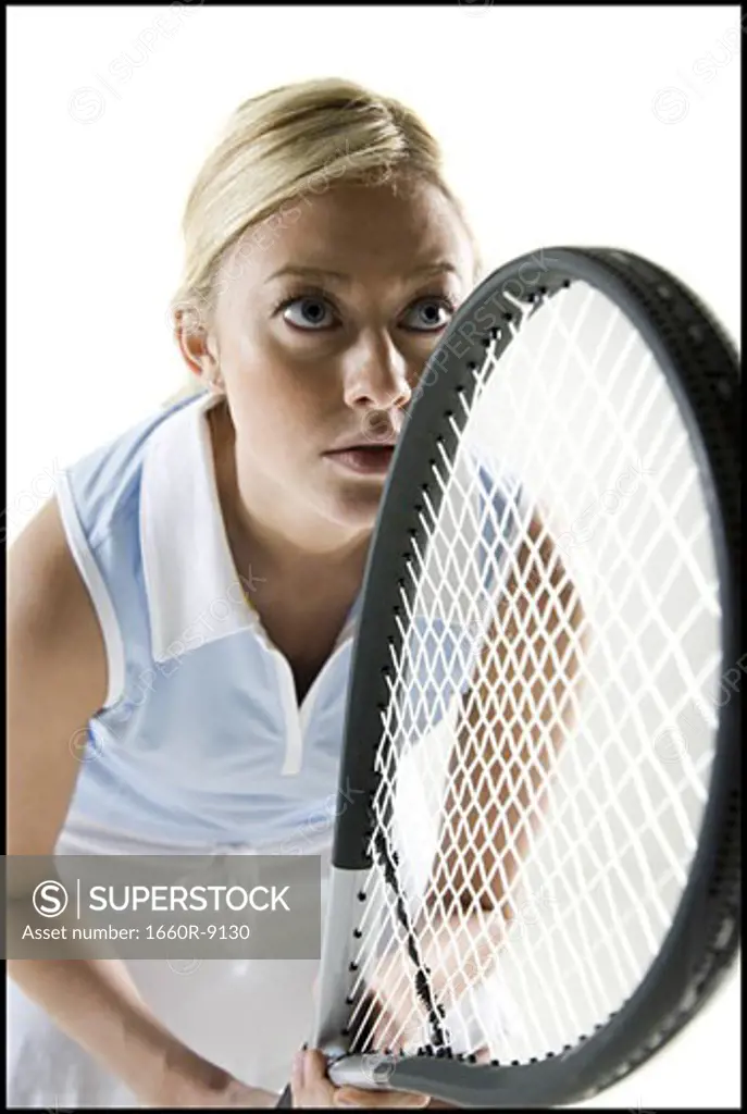 Close-up of a young woman holding a tennis racket