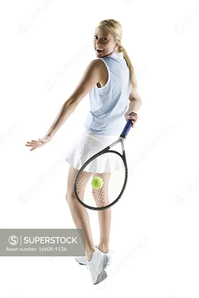 Rear view of a young woman playing tennis