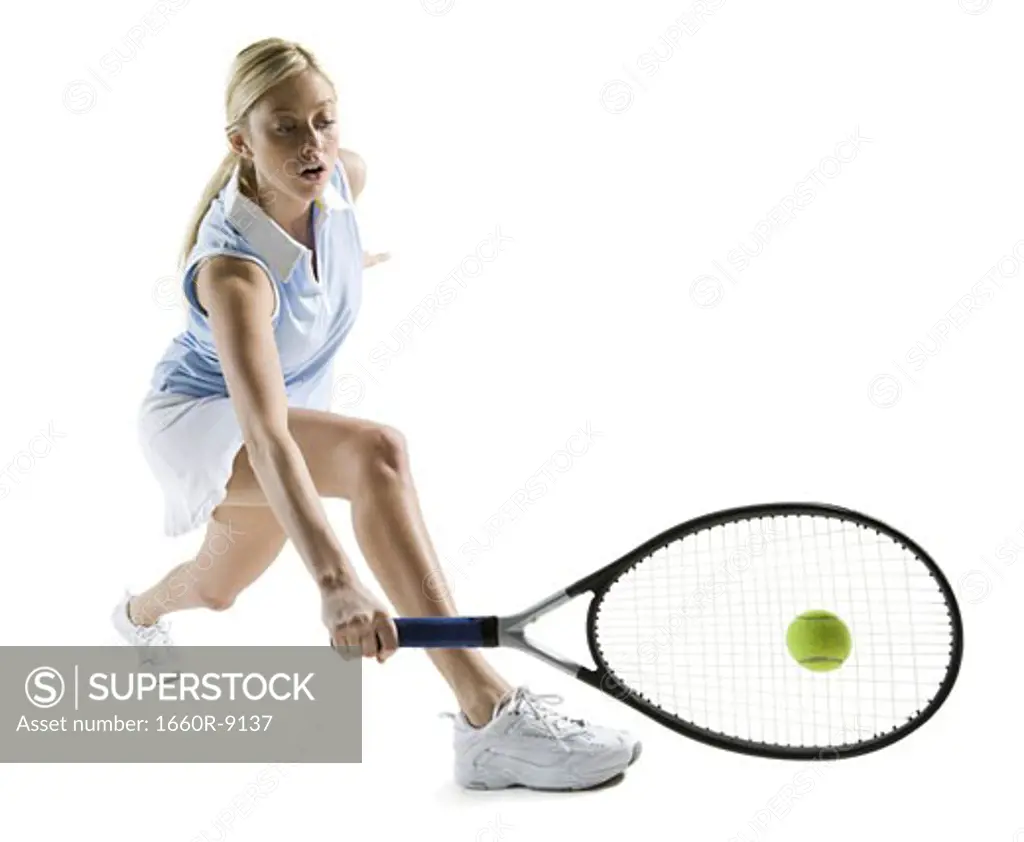 Young woman hitting a tennis ball