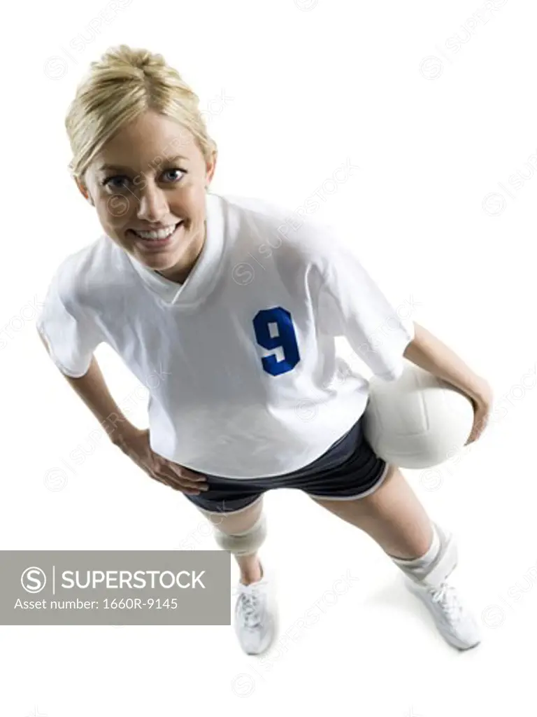 High angle view of a young woman holdoing a volleyball