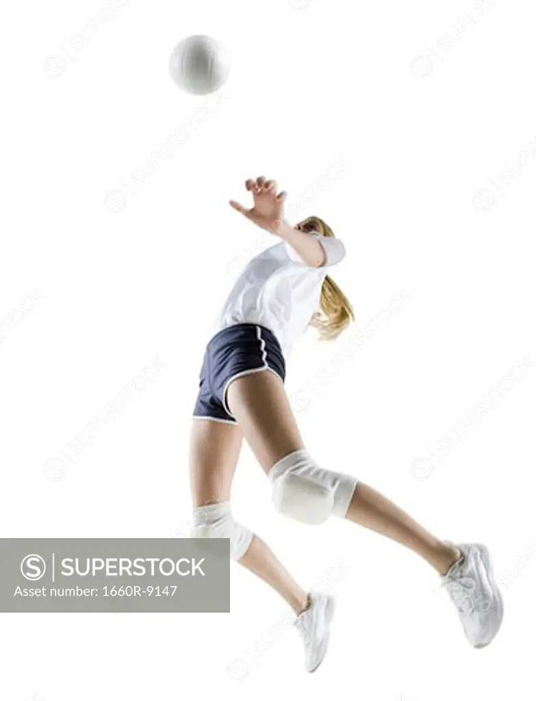 Low angle view of a young woman playing volleyball