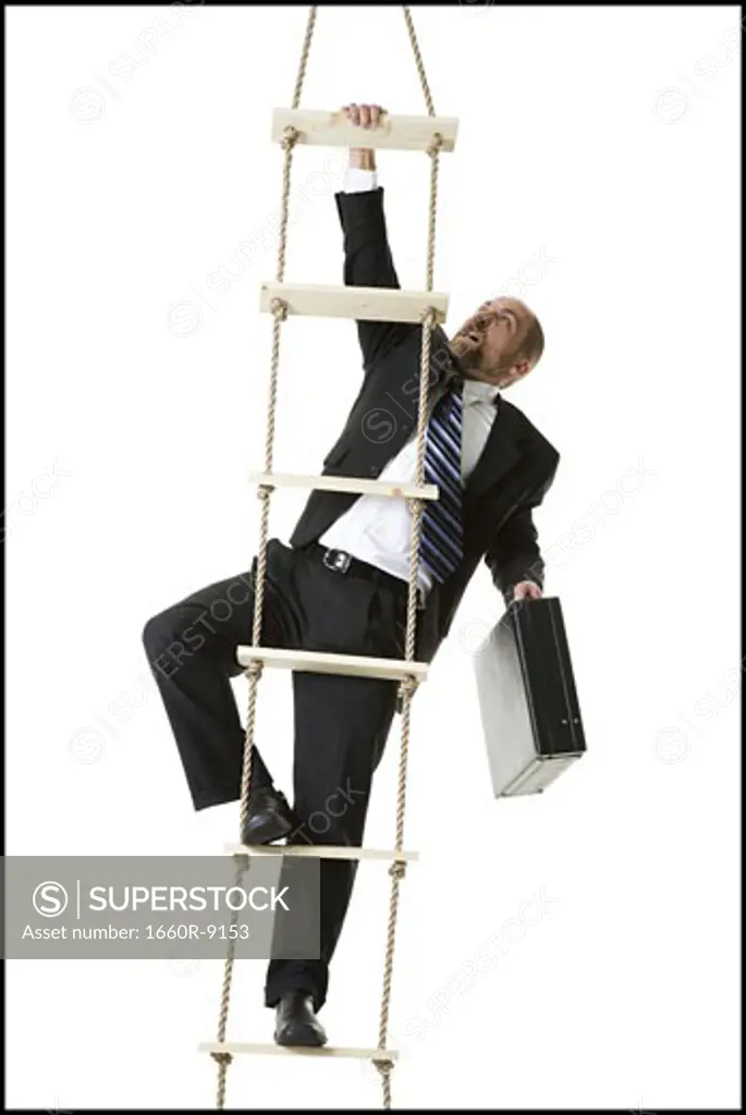 Low angle view of a businessman climbing a ladder