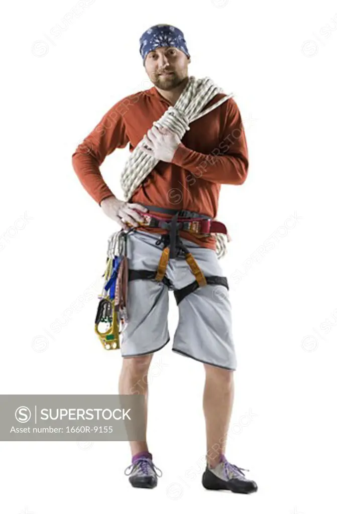 Portrait of a young man with rock-climbing gear