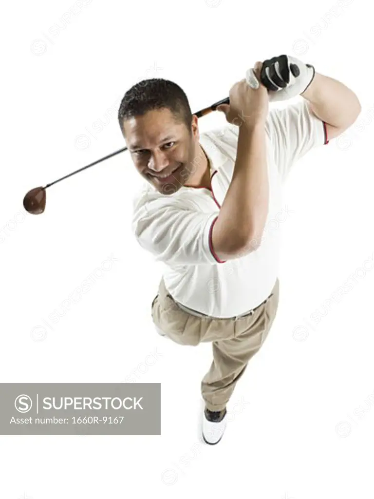 High angle view of a mid adult man swinging a golf club
