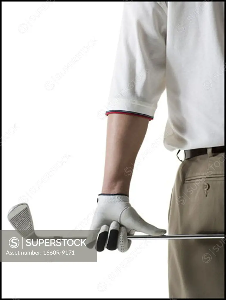 Mid section view of a mid adult man holding a golf club