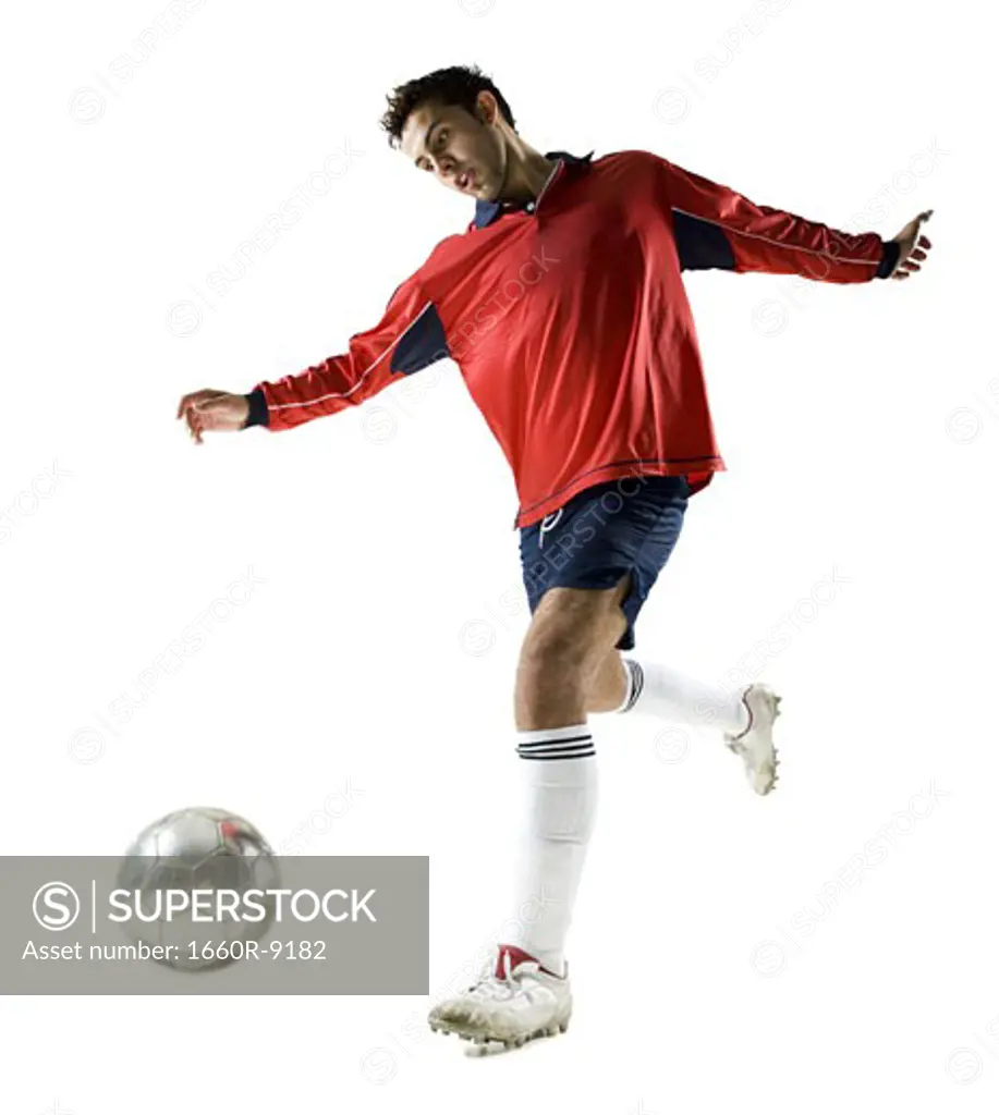 Low angle view of a young man playing with a soccer ball