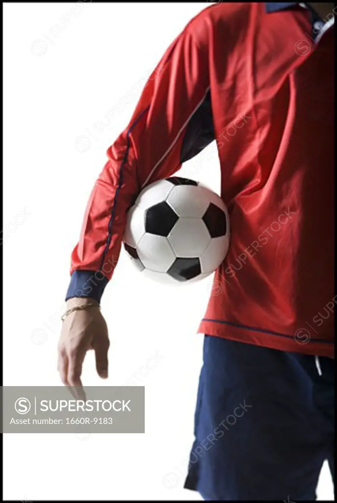 Mid section view of a young man holding a soccer ball