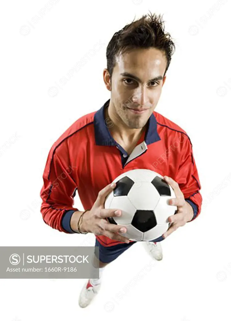 Portrait of a young man holding a soccer ball