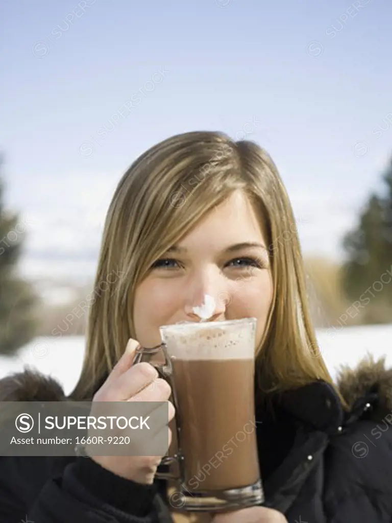 Portrait of a young woman drinking hot cocoa