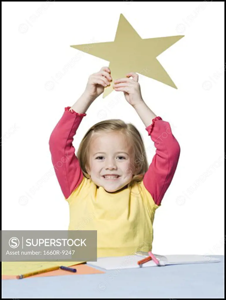 Portrait of a girl holding a star