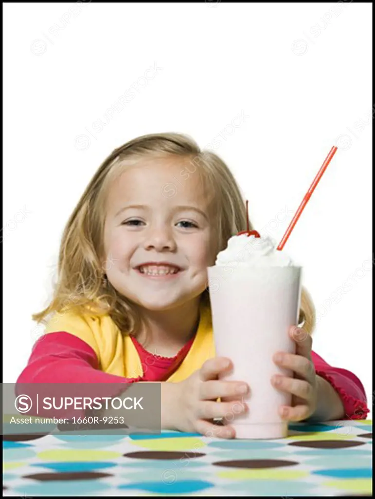 Portrait of a girl holding a glass of ice cream soda