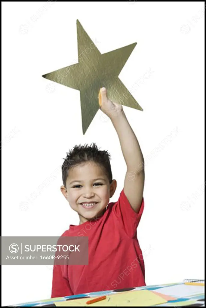 Portrait of a boy holding a star