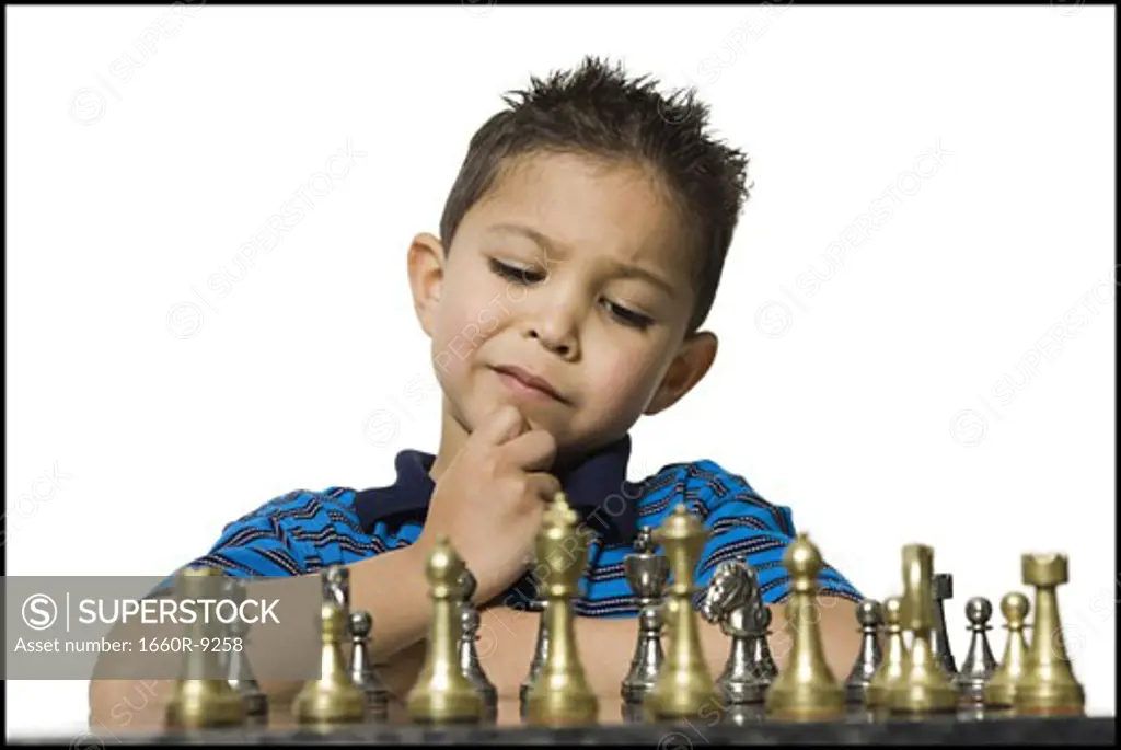 Close-up of a boy playing chess